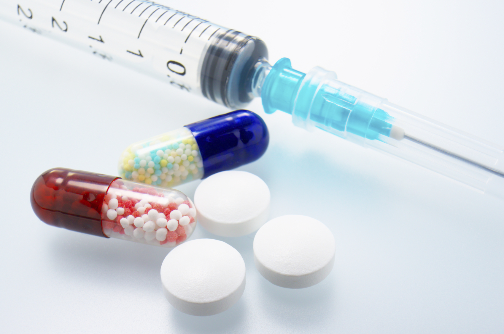 Closeup of medicines and syringes.
